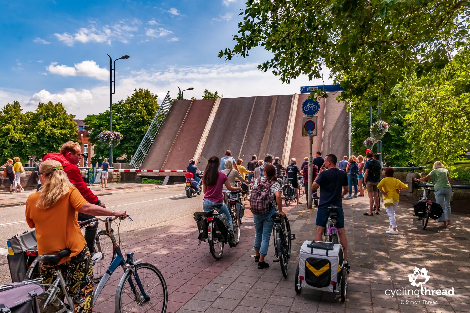Cyclists waiting at a raised bridge in Leeuwarden