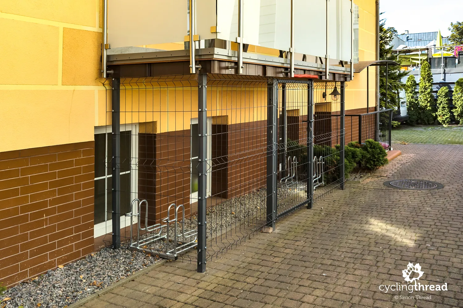 Secure bicycle storage beneath a balcony